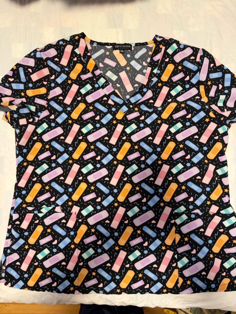 Black V-Neck Printed Scrub Top with Pastel Bandage Pattern